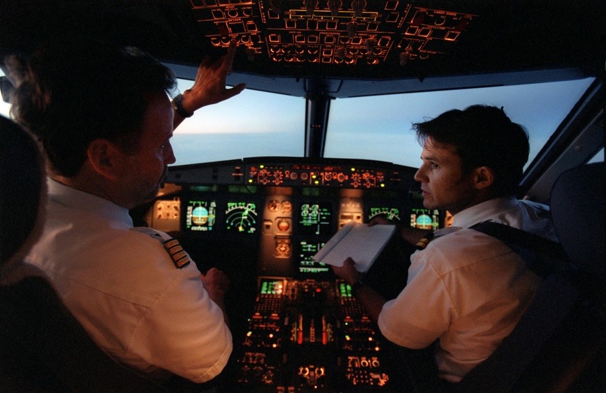 Zwei Piloten sitzen im Cockpit eines Airbus A320 der Edelweiss Air waehrend eines Fluges nach Mallorca, aufgenommen am 22. Maerz 2002. (KEYSTONE/Martin Ruetschi) : FILM]