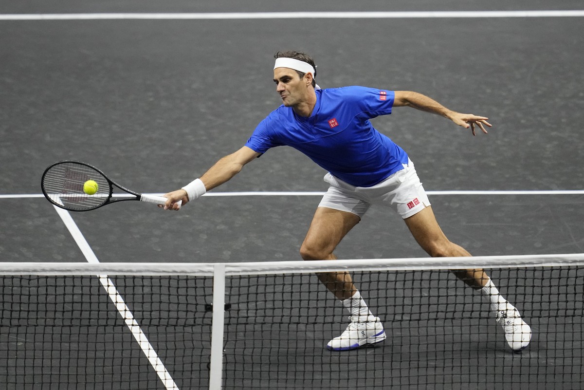 Team Europe's Roger Federer playing with Rafael Nadal volleys a return during the Laver Cup doubles match against Team World's Jack Sock and Frances Tiafoe at the O2 arena in London, Friday, ...