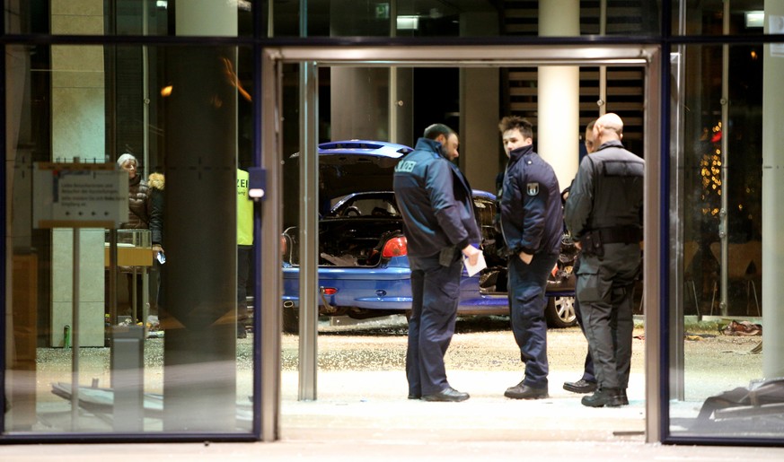 epa06405106 Police officers stand in front of a damaged car in the lobby of the party headquarters of the Social Democratic Party of Germany (SPD) after it crashed into the building in Berlin, Germany ...