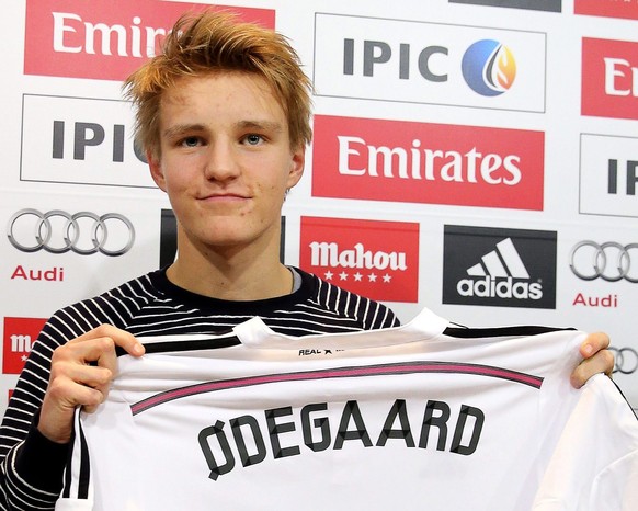Stolz präsentiert Martin Ödegaard sein erstes Real-Shirt.