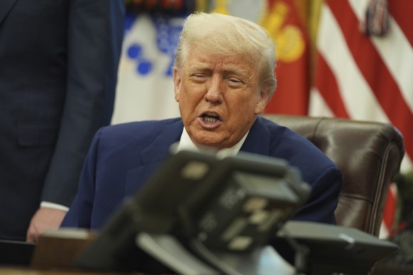 President Donald Trump speaks on the phone to Britian&#039;s Prime Minister Keir Starmer aon a trade deal between the US and United Kingdom in the Oval Office of the White House, Thursday, May 8, 2025 ...