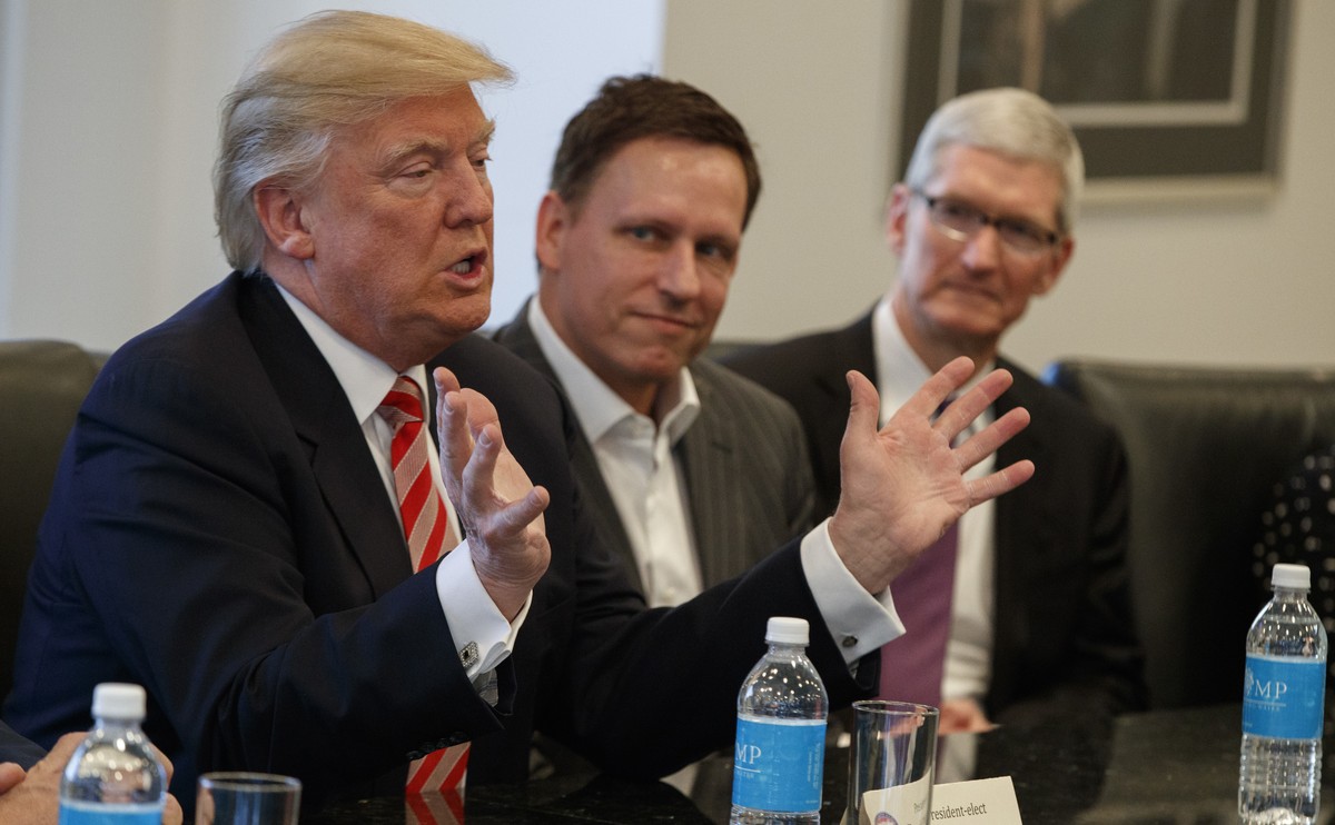 Apple CEO Tim Cook, right, and PayPal founder Peter Thiel, center, listen as President-elect Donald Trump speaks during a meeting with technology industry leaders at Trump Tower in New York, Wednesday ...