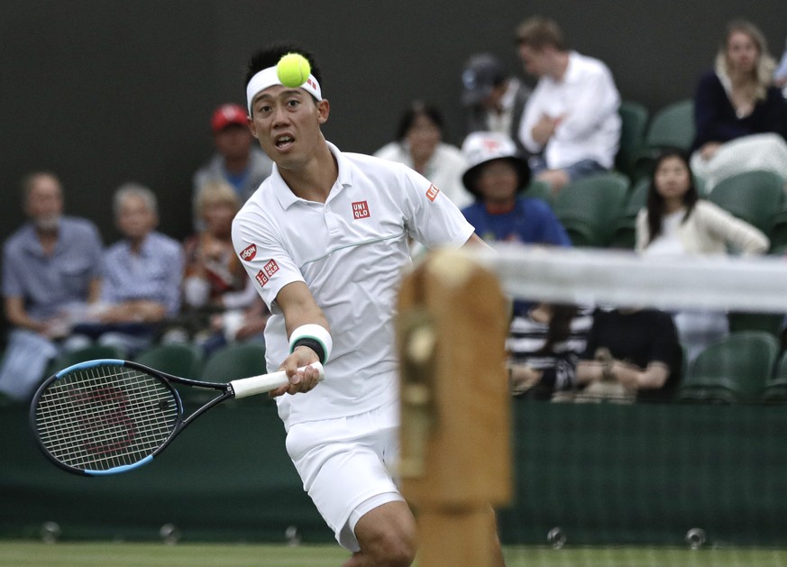 Japan&#039;s Kei Nishikori returns the ball to Kazakhstan&#039;s Mikhail Kukushkin in a men&#039;s singles match during day seven of the Wimbledon Tennis Championships in London, Monday, July 8, 2019. ...