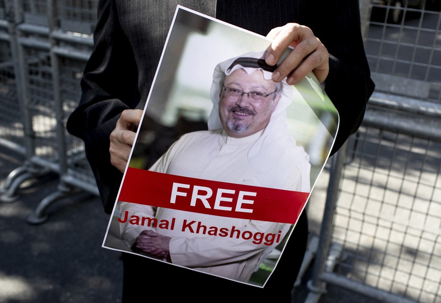 epa07071347 A protester holds a picture of Saudi Journalist Jamal Khashoggi during a demonstration organized by Turkish-Arabic Media Association in front of the Saudi Arabian consulate in Istanbul, Tu ...