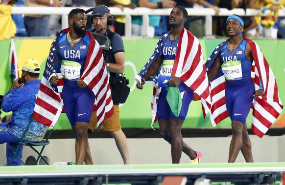 epa05501520 (L-R) Tyson Gay, Justin Gatlin, and Mike Rodgers react after the men&#039;s 4x100m relay final of the Rio 2016 Olympic Games Athletics, Track and Field events at the Olympic Stadium in Rio ...