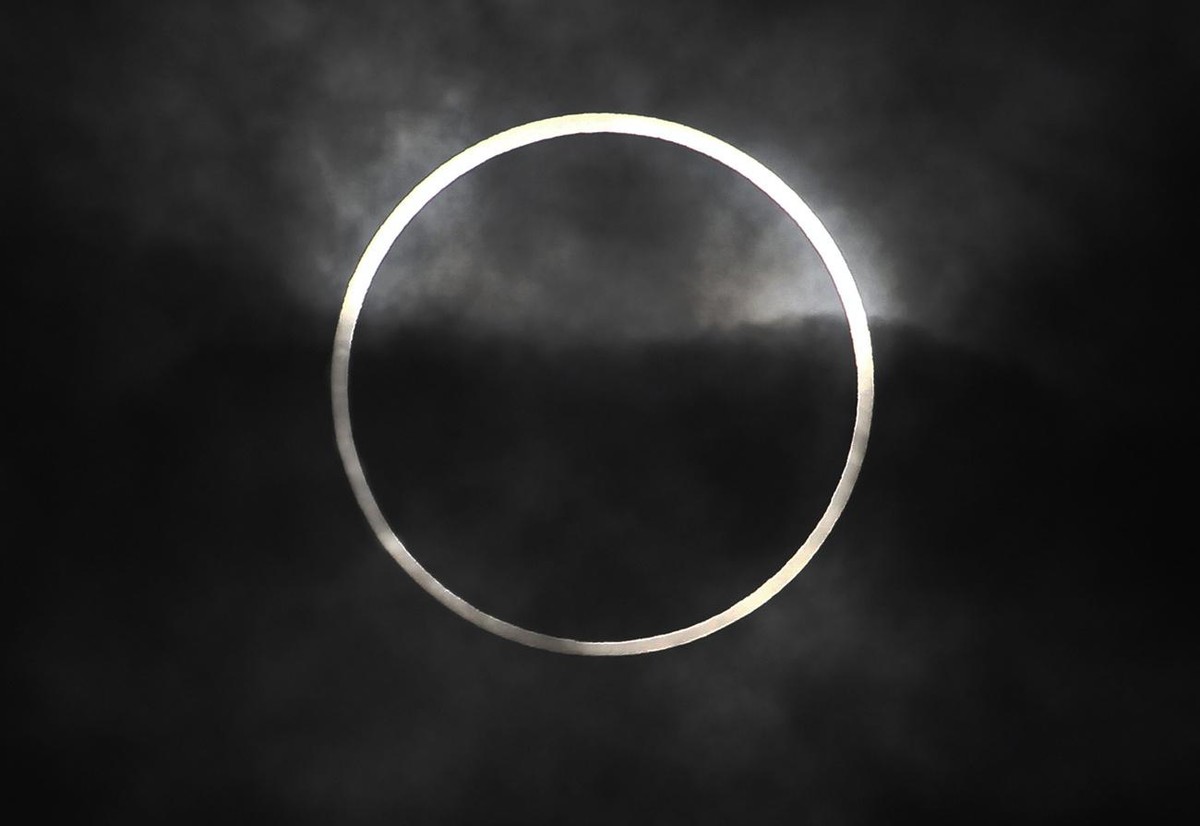 An annular solar eclipse in seen from Machida, on the outskirts of Tokyo, Monday, May 21, 2012. Millions across Asia are watching as a rare "ring of fire" eclipse is crossing their skies. Th ...