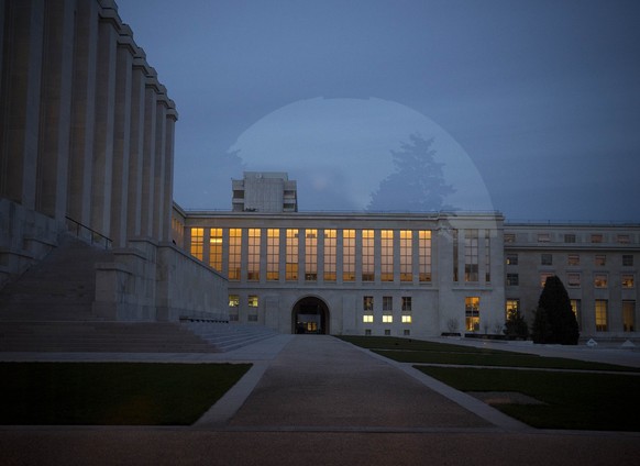 In this Tuesday, Jan. 28, 2014 picture, the floor of the building where the Syrian peace talks take part is illuminated at the United Nations headquarters in Geneva, Switzerland, with a reflection of  ...