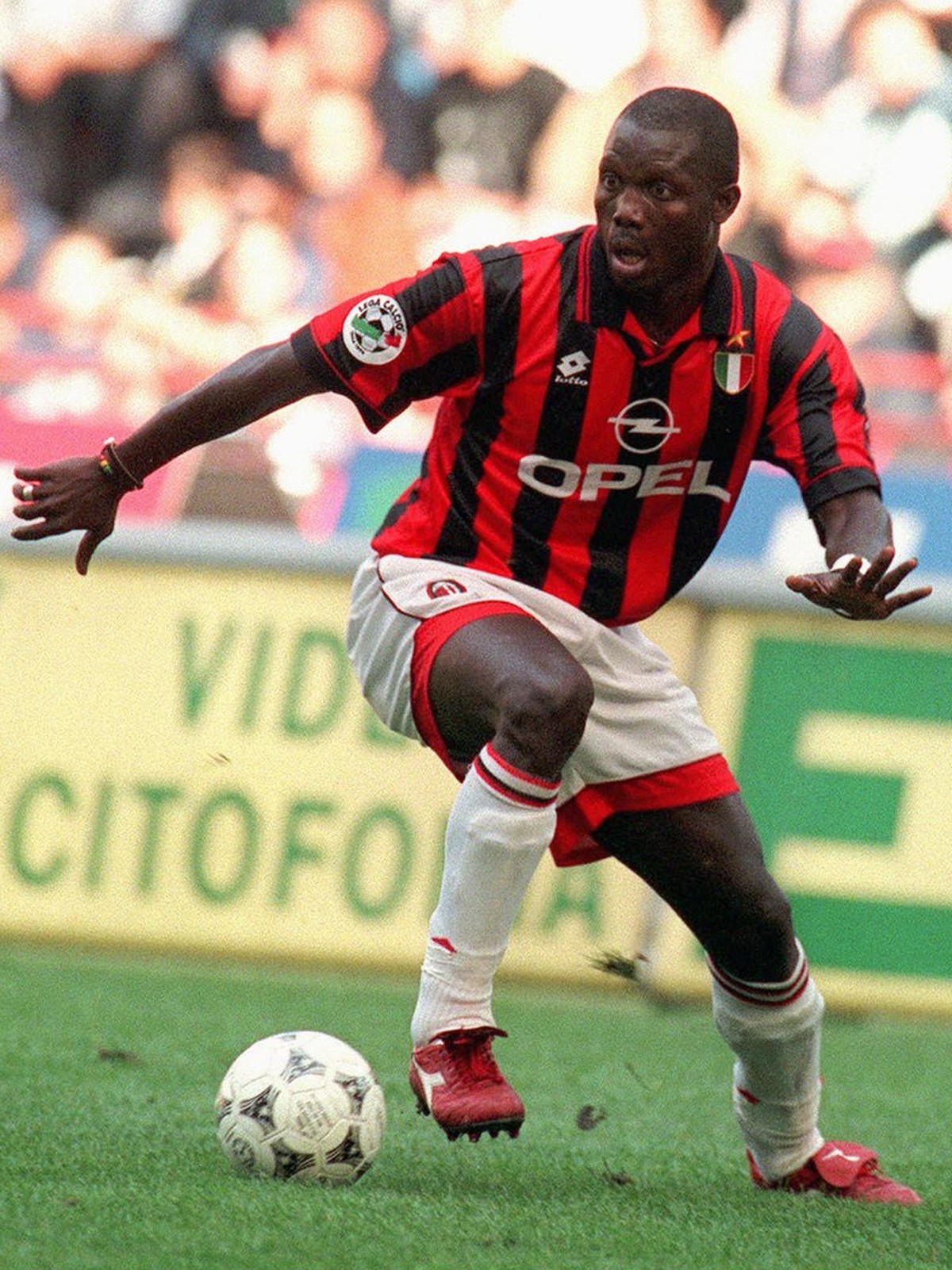 Milan's forward George Weah, left, dribbles past Napoli defender Mirko Taccola during their Italian major league match in Milan Sunday, October 20, 1996. Weah scored first two goals in Milan' ...