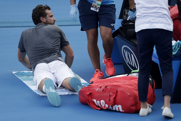 Latvia&#039;s Ernests Gulbis waits to receive treatment during his first round match against Switzerland&#039;s Stan Wawrinka at the Australian Open tennis championships in Melbourne, Australia, Tuesd ...