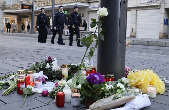 epa11940039 Flowers and candles are placed at the crime scene in Mannheim, Germany, 04 March 2025, where a vehicle drove into pedestrians on 03 March 2025. According to statements from police, a vehic ...