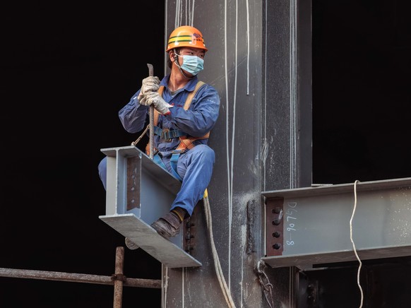 epa10262579 A man works at the construction site in Shanghai, China, October 24, 2022. China's gross domestic product (GDP) rose to 3.9 percent year-on-year in the third quarter of 2022, the National B...