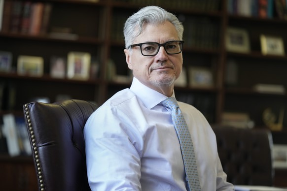 FILE - Judge Juan M. Merchan poses in his chambers in New York, March 14, 2024. On Friday, April 19, 2024, The Associated Press reported on stories circulating online incorrectly claiming Merchan told ...