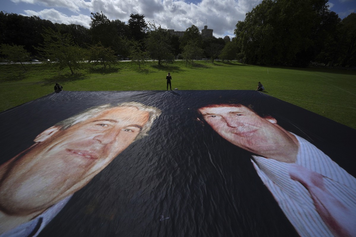 Activist from the protest group Everyone Hates Elon put up a poster of President Donald Trump and Jeffrey Epstein, ahead of the state visit by U.S. President Donald Trump, in Windsor, England, Monday, ...