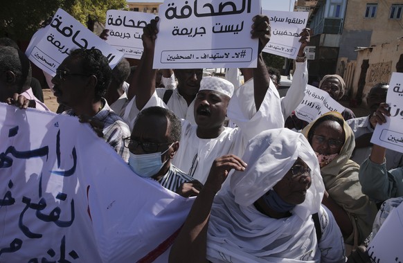 Sudanese journalist protest in Khartoum, Sudan, Tuesday, Nov.16, 2021. The placard in the middle reads: &quot;Journalism is not a crime&quot; (AP Photo/Marwan Ali)