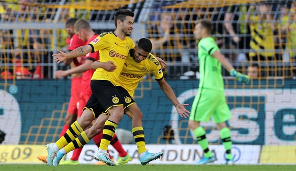 epa07842420 Dortmund&#039;s Raphael Guerreiro (L) celebrates scoring the third goal with Dortmund&#039;s Achraf Hakimi (R) during the German Bundesliga soccer match between Borussia Dortmund and Bayer ...