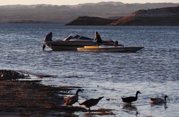 epa10048903 People gather on boats at Lake Mead National Recreation Area in Boulder City, Nevada, USA, 02 July 2022. The U.S. Bureau of Reclamation recently reported that the water levels of Lake Mead ...