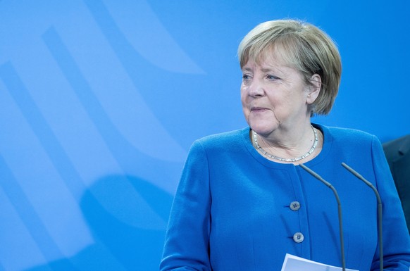 epa09573591 German Chancellor Angela Merkel (R, CDU) during the handover of the annual report of the German Council of Economic Experts (Wirtschaftsweise) alongside Olaf Scholz, SPD candidate for Chan ...