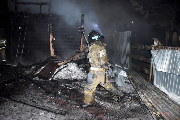 In this photo released by Russian Emergency Ministry Press Service, firefighters work at the site of fire of a nursing home in the town of Borovsky, western Siberia, Russia, Saturday, Jan. 9, 2021. Ru ...