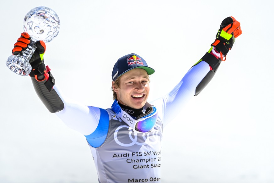 Marco Odermatt of Switzerland holds the men&#039;s Giant-Slalom overall leader crystal globe trophy in the finish area during the second run of the men&#039;s Giant-Slalom race at the FIS Alpine Skiin ...