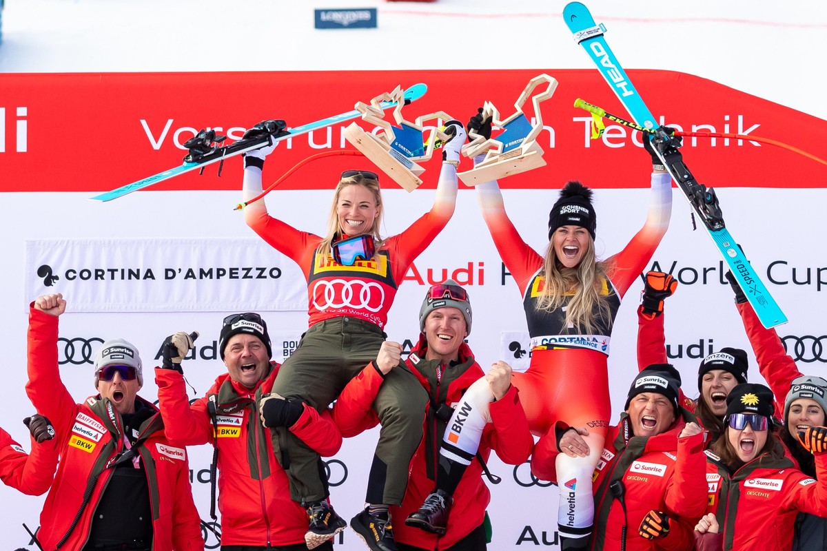 epa11836203 Second placed Lara Gut-Behrami (L) of Switzerland and her teammate third placed Corinne Suter (R) of Switzerland celebrate on the podium after the Women's SuperG race at the FIS Alpin ...