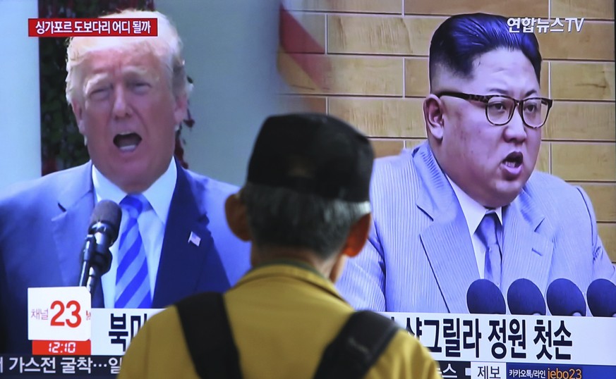 A man watches a TV screen showing file footage of U.S. President Donald Trump, left, and North Korean leader Kim Jong Un during a news program at the Seoul Railway Station in Seoul, South Korea, Sunda ...