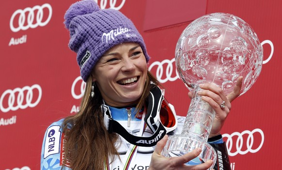 FILE - In this March 17, 2013 file photo Slovenia&#039;s Tina Maze poses with the alpine ski World cup overall trophy in Lenzerheide Switzerland. Maze will talk about her career plans later on Thursda ...