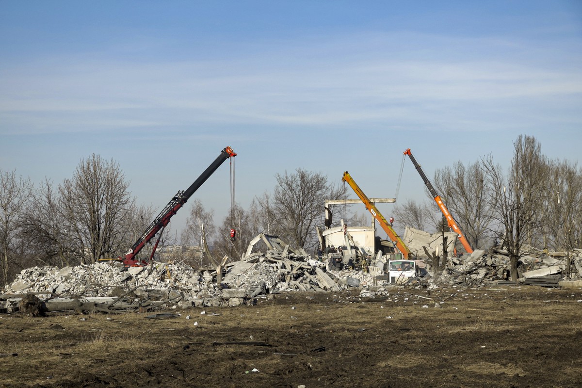 Workers clean rubbles after Ukrainian rocket strike in Makiivka, in Russian-controlled Donetsk region, eastern Ukraine, Tuesday, Jan. 3, 2023. Russia's defense ministry says 63 of its soldiers ha ...