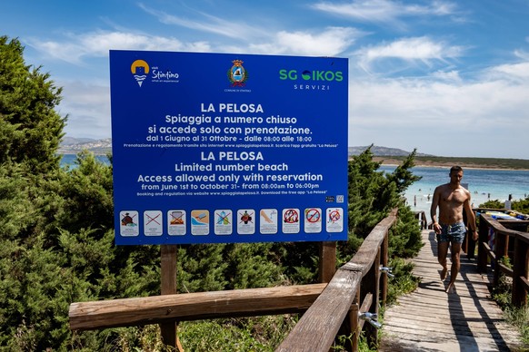 Travel Destination: Sardinia A warning board showing the rules and indicating the closed number access is being pictured by La Pelosa beach in Stintino, Sardinia, Italy, on August 5, 2024. La Pelosa b ...