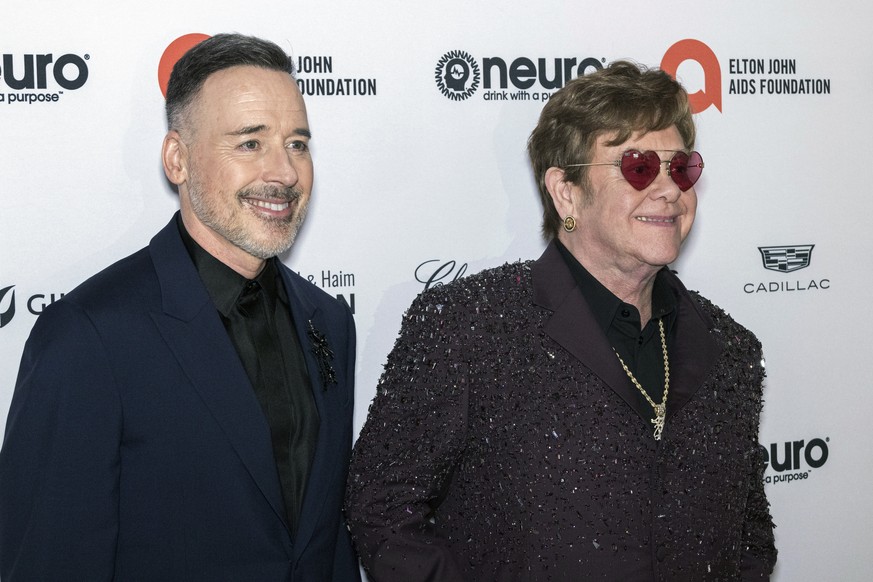 David Furnish, left, and Elton John arrive at the Elton John AIDS Foundation&#039;s 31st Annual Academy Awards Viewing Party, Sunday, March 12, 2023, at the West Hollywood Park in West Hollywood, Cali ...