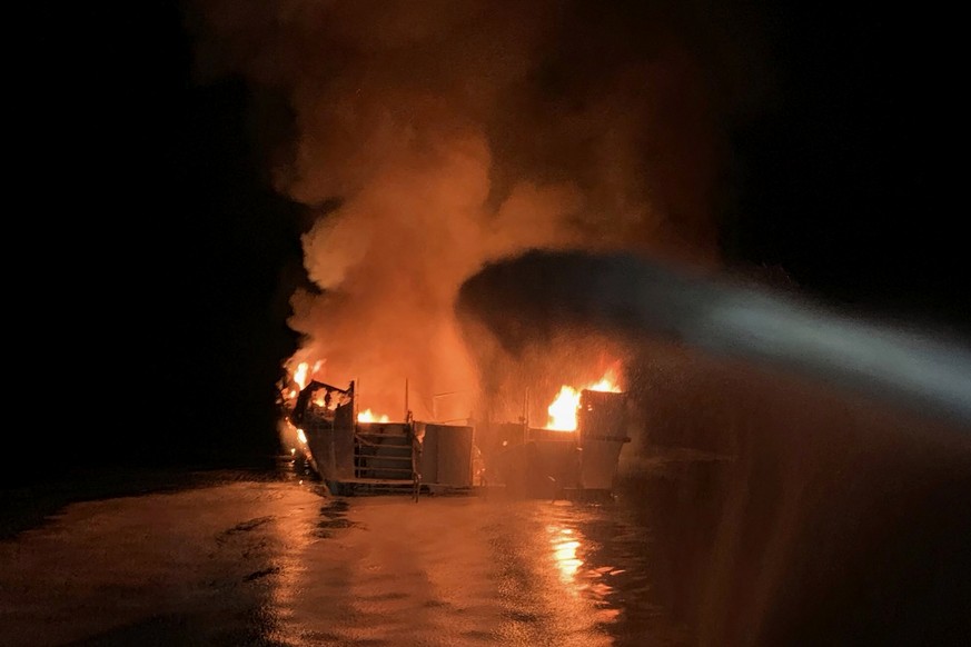 In this photo provided by the Ventura County Fire Department, VCFD firefighters respond to a boat fire off the coast of southern California, Monday, Sept. 2, 2019. The U.S. Coast Guard said it has lau ...