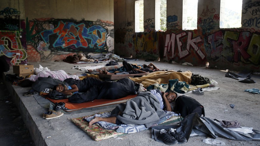 In this photo taken on Tuesday, Aug. 14, 2018, migrants sleep on the floor of a makeshift migrant camp in Bihac, 450 kms northwest of Sarajevo, Bosnia. Impoverished Bosnia must race against time to se ...