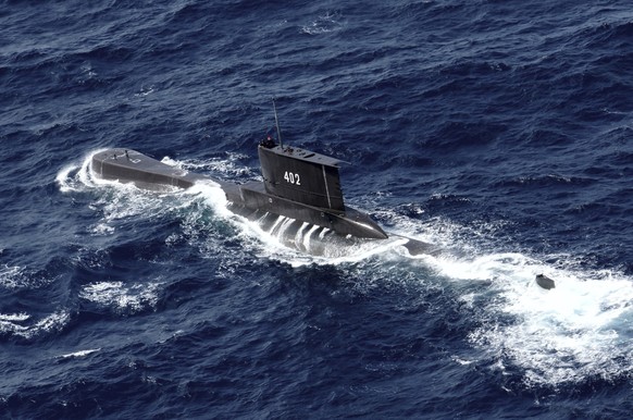 Indonesian Navy submarine KRI Nanggala sails in the waters off Tuban, East Java, Indonesia, as seen in this aerial photo taken from Indonesian Navy helicopter of 400 Air Squadron, in this Monday, Oct. ...