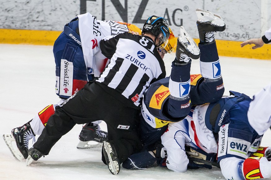 Zuerichs Topscorer Denis Hollenstein, Schiedsrichter Stany Gnemmi, Zugs Dennis Everberg und Zuerichs Pius Suter, von links, im Eishockey Meisterschaftsspiel der National League zwischen dem EV Zug und ...