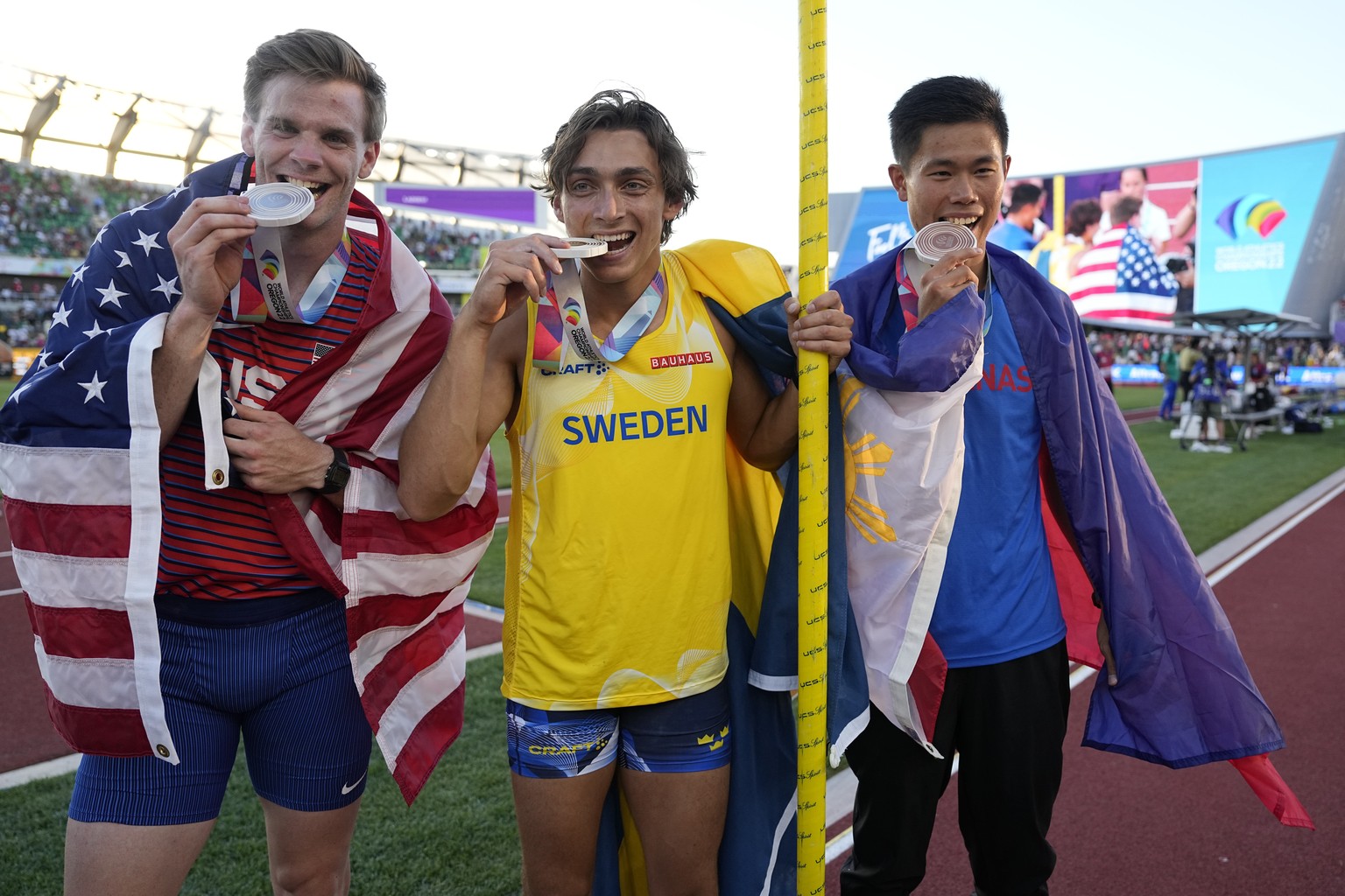 Gold medalist Armand Duplantis, of Sweden, center, stands with silver medalist Christopher Nilsen, of the United States, left, and bronze medalist Ernest John Obiena, of the Philippines, after the men ...