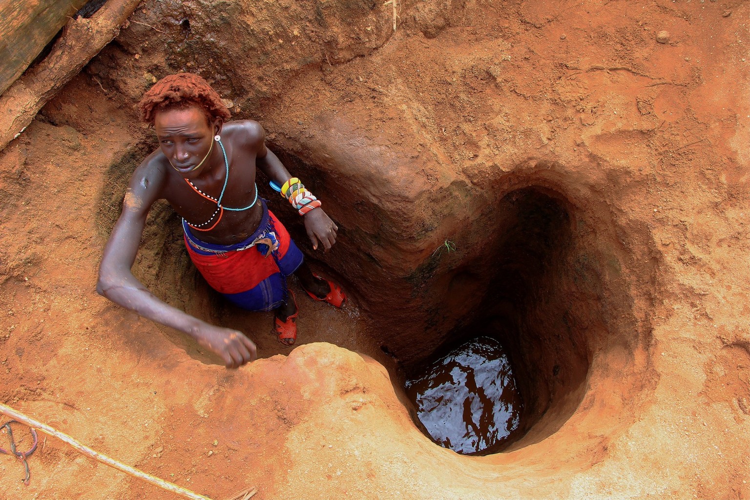 NAIROBI, KENYA - NOVEMBER 23: A man tries to get clean water during the food and water shortages which also affects the areas where people live in Nairobi, Kenya on November 23, 2022. A drought in nor ...