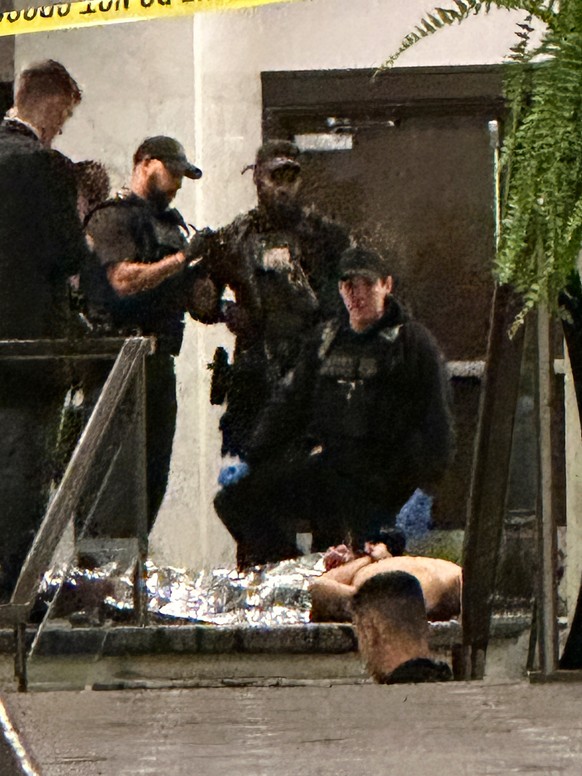 Members of law enforcement control shooting suspect Cole Tomas Allen during the White House Correspondents Dinner, Saturday, April 25, 2026, in Washington. (AP Photo/Alex Brandon) ADDITION: Adds name  ...