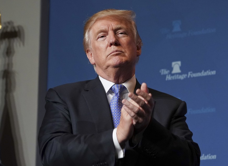 President Donald Trump applauds members of the audience before speaking at the Heritage Foundation&#039;s annual President&#039;s Club meeting, Tuesday, Oct. 17, 2017 in Washington. (AP Photo/Pablo Ma ...