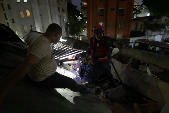 epaselect epa13062399 Members of the Fire Department rescue a person after two strong earthquakes struck the Venezuelan Caribbean; in Caracas, Venezuela, 24 June 2026. Two earthquakes, the first 7.2-m ...