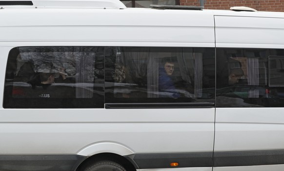 epa06644539 A boy looks throught window as a bus leaves the US Embassy in Moscow, Russia, 04 April 2018. In response the US explelling Russian diplomats in response to the the Skripal poisoning case,  ...