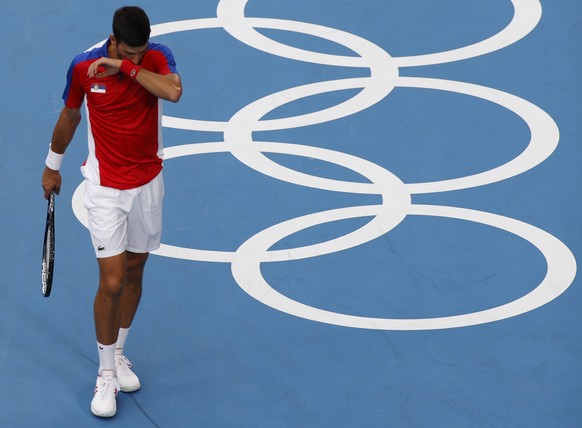 epa09379054 Novak Djokovic of Serbia reacts during the Men&#039;s Singles Semifinal Tennis events of the Tokyo 2020 Olympic Games at the Ariake Coliseum in? Tokyo, Japan, 30 July 2021. EPA/RUNGROJ YON ...