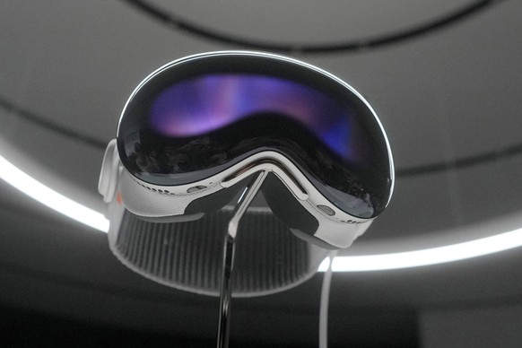 File - The Apple Vision Pro headset is on display in a showroom on the Apple campus after its unveiling on Monday, June 5, 2023 in Cupertino, California.  The Vision Pro is an expensive headset that...