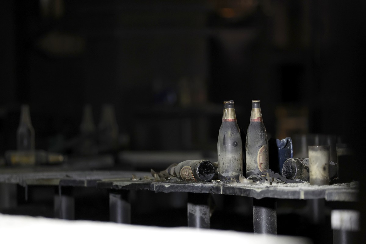 epa13107714 Damaged beer bottles stand inside a pub after a fire in Bangkok, Thailand, 13 July 2026. At least 27 people were killed after a fire engulfed the pub, according to Thai Prime Minister Anut ...