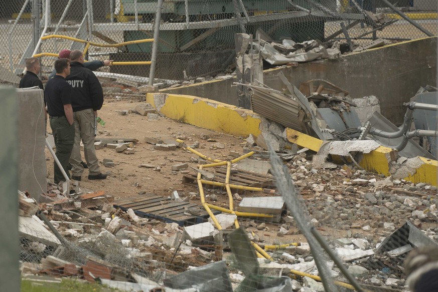 Polizisten begutachten den Schaden nach der Explosion.