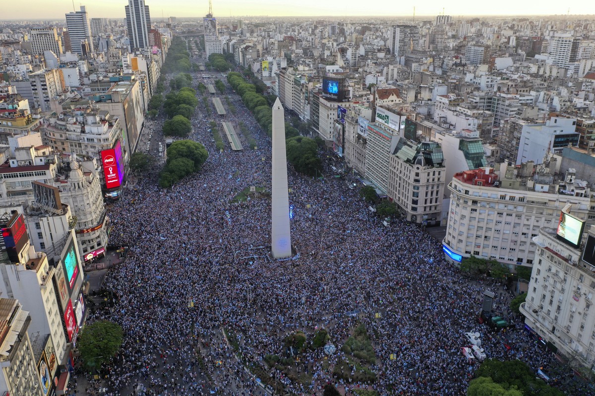 Argentina soccer fans celebrate their team's victory over Croatia after watching the team's World Cup semifinal match in Qatar on TV, in downtown Buenos Aires, Argentina, Tuesday, Dec. 13, 2 ...