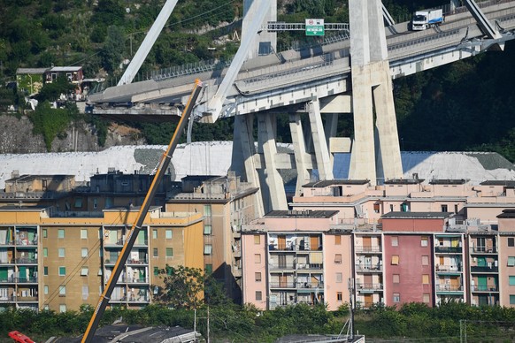 epa06958795 A general view showing a part of the partially collapsed Morandi bridge, in Genoa, Italy, 19 August 2018. Italian authorities, worried about the stability of remaining large sections of th ...