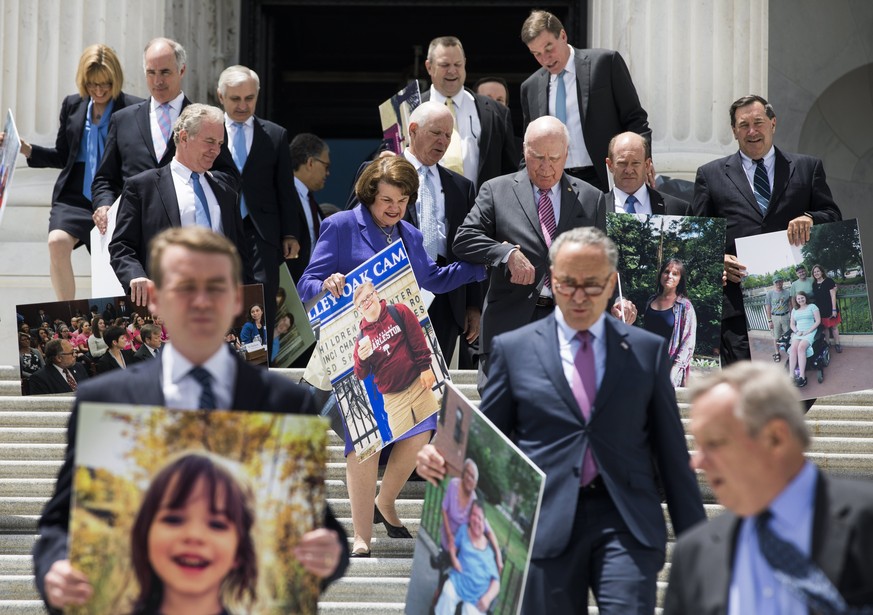 epaselect epa06053021 Democratic Senator from California Dianne Feinstein (C), along with other Democratic Senators, hold pictures of constituents whom they said will be adversely affected by the Repu ...