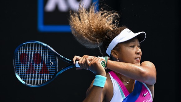 epaselect epa09690336 Naomi Osaka of Japan returns to Camila Osorio of Colombia in their first round match on Day 1 of the Australian Open tennis tournament, at Melbourne Park, in Melbourne, Australia, 17 January 2022.  EPA/DAVE HUNT AUSTRALIA AND NEW ZEALAND OUT