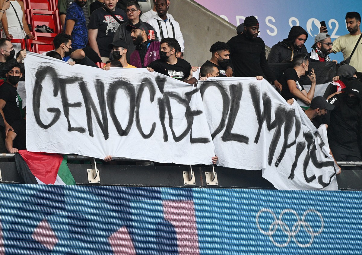 epa11500750 Supporters of Palestine unveil a banner during the Men Group D Match Israel vs Paraguay of the Soccer competitions in the Paris 2024 Olympic Games, at the Parc de Princes stadium in Paris, ...