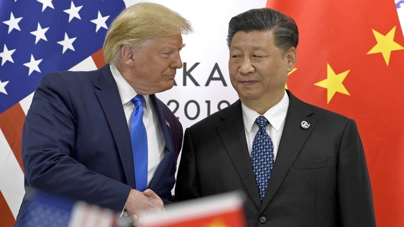 FILE - In this June 29, 2019, file photo, U.S. President Donald Trump, left, shakes hands with Chinese President Xi Jinping during a meeting of the G-20 summit in Osaka, western Japan. Although Presid ...