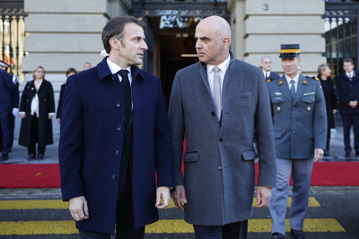 epa10976296 Switzerland President Alain Berset (L) welcomes French President Emmanuel Macron and the other members of Swiss government in front of the Federal Palace, the Swiss Parliament building, in ...